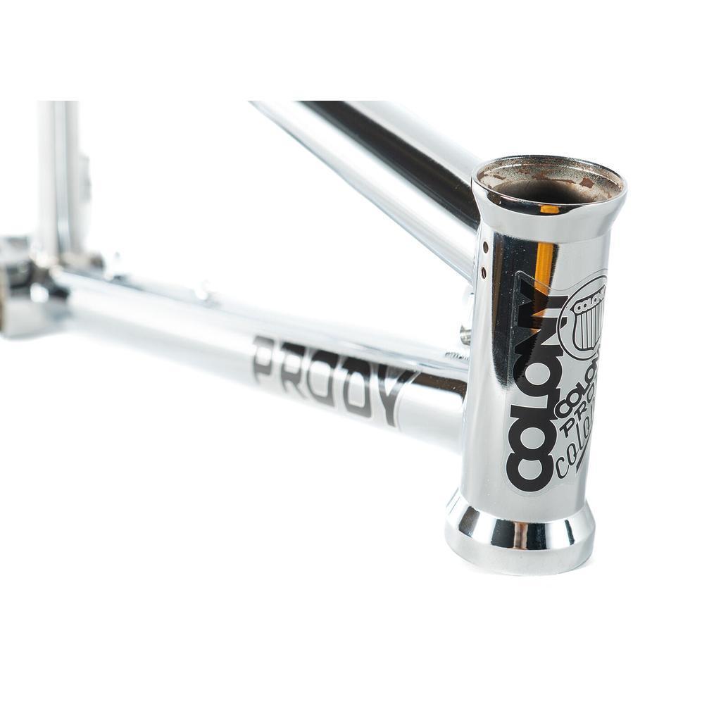 Close-up of the Colony Prody Frame, a chrome BMX freestyle bike frame, highlighting the "Colony" logo and "Prody" model name on the head tube and adjoining top and down tubes.