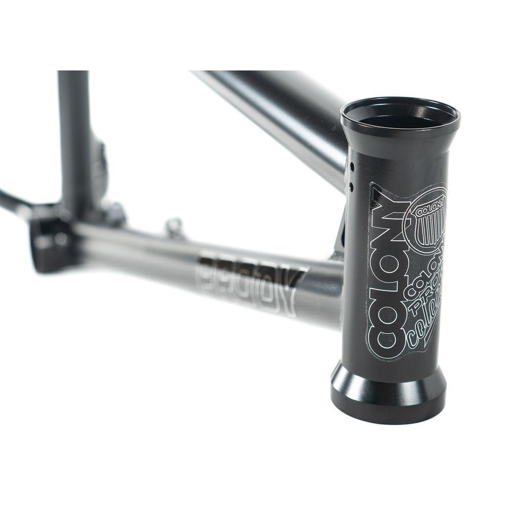 Close-up of a black Colony Prody Frame BMX with "COLONY" and related logos in white on the head tube and side.