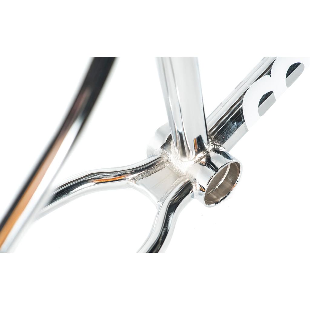 Close-up of the Colony Prisma Frame’s bottom bracket, highlighting welded joints and polished silver finish—ideal for riders seeking a street BMX frame with progressive geometry.