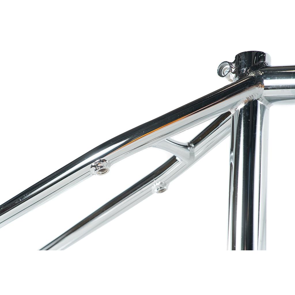 Close-up of the polished chrome Colony Prisma Frame, showcasing the seat tube, top tube, and rear triangle junction with its progressive geometry.