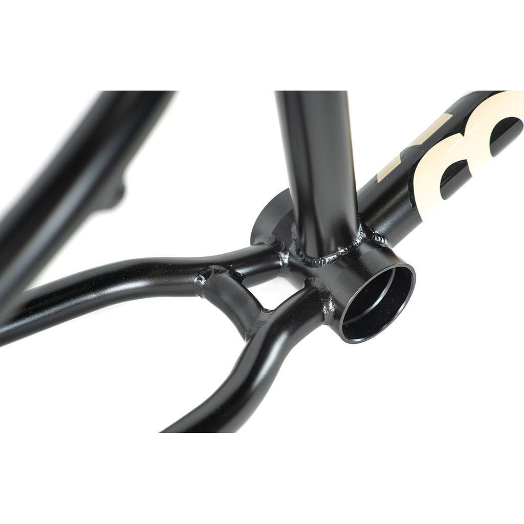 Close-up of the Colony Cadet 20 inch Frame in black chromoly, highlighting the welds at the bottom bracket area and rear triangle with part of its logo visible.