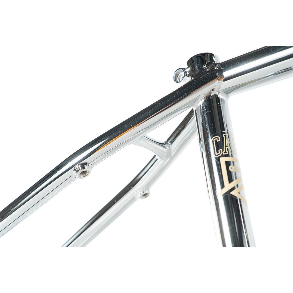 Close-up of the Colony Cadet 20 inch Frame, showing shiny chromoly tubing, visible welds, and partial decals at the seat tube and top tube junction.