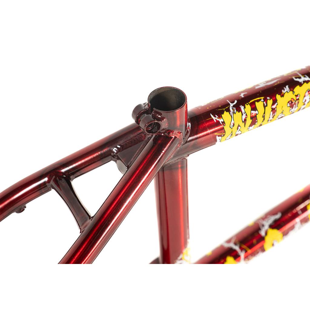 Close-up of the Colony Injustice Frame (Tom Justice Signature) in red metallic with yellow and white graphics, highlighting the seat tube and seat post clamp area.