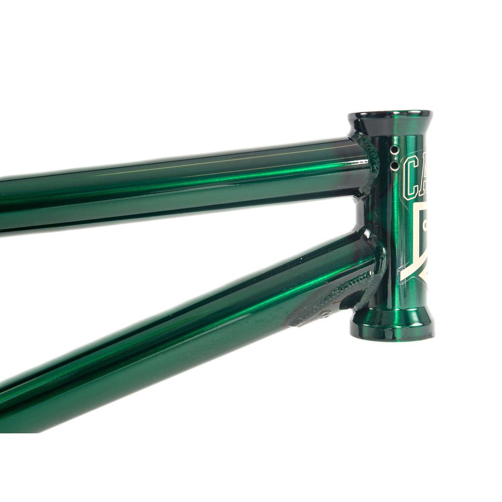 Close-up of a glossy dark green Colony Cadet 18 Inch Frame head tube with partial white logo text.
