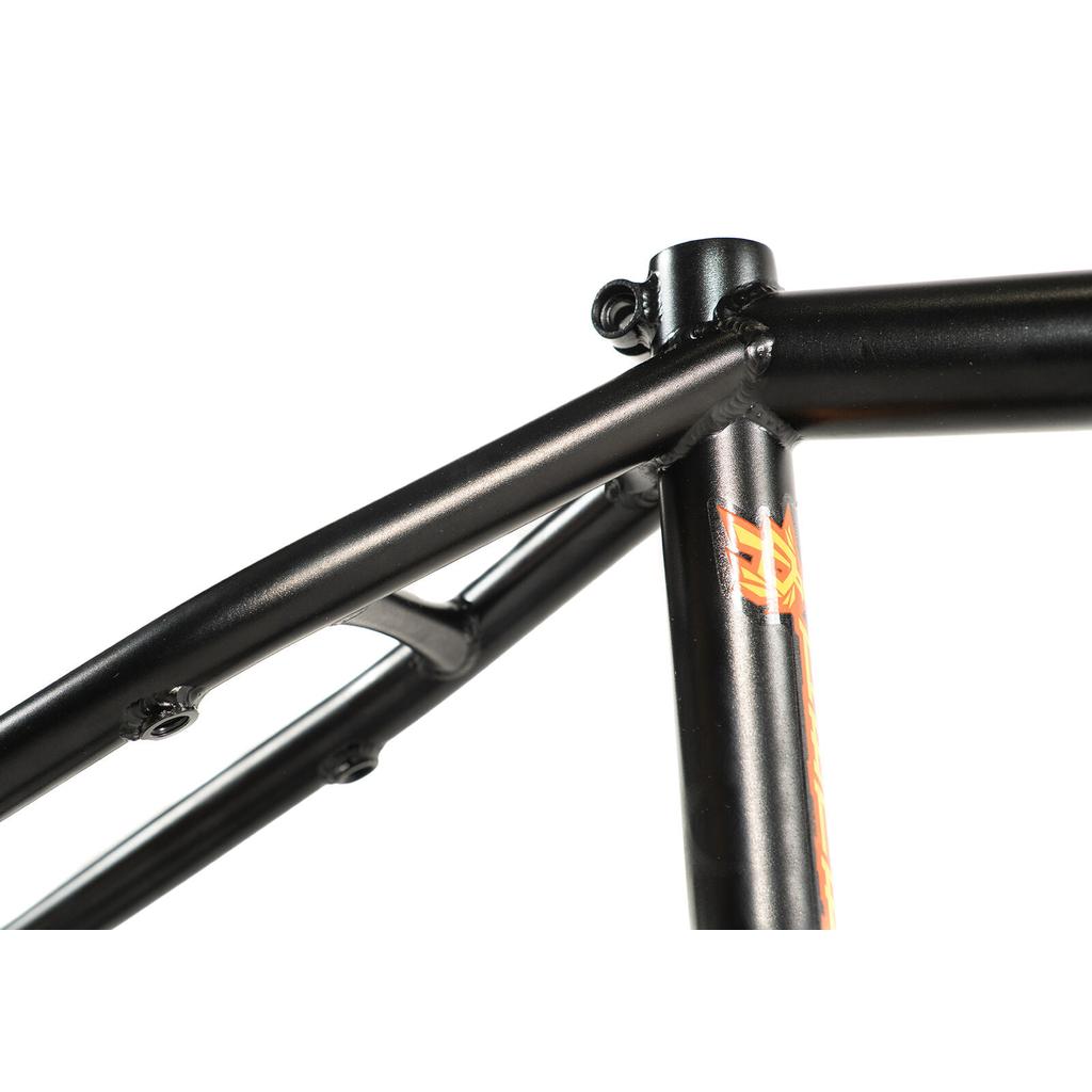 Close-up of a black BMX frame highlights the seat tube, top tube, and seat stay junction with visible welds and a small orange decal—this is the Colony Balkan Eagle Frame (Renato Rancso Signature), expertly crafted for performance.