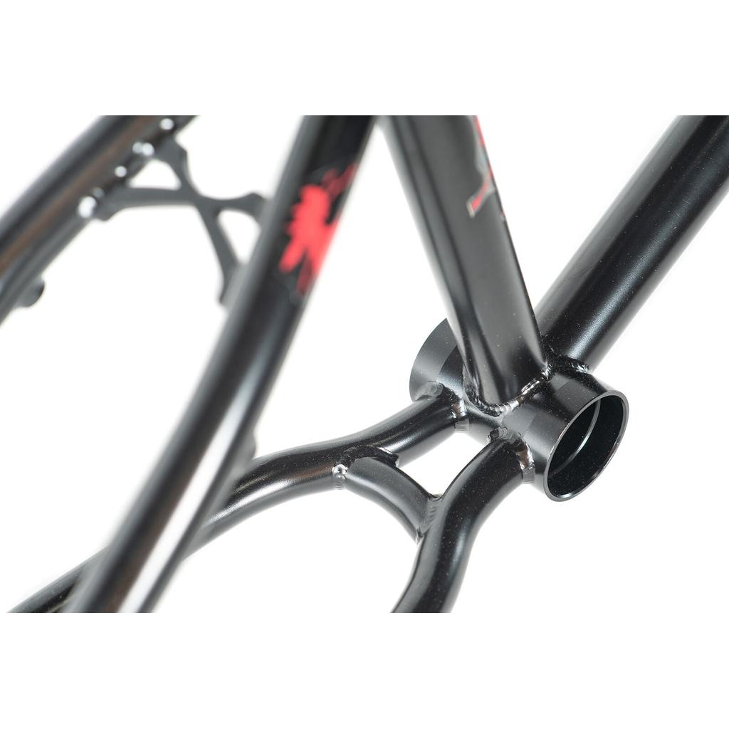 Close-up of a black Colony Bloody Oath Frame Kit, highlighting the welded joints and bottom bracket, with part of the red logo visible—a limited edition BMX frame inspired by Nick Richardson.