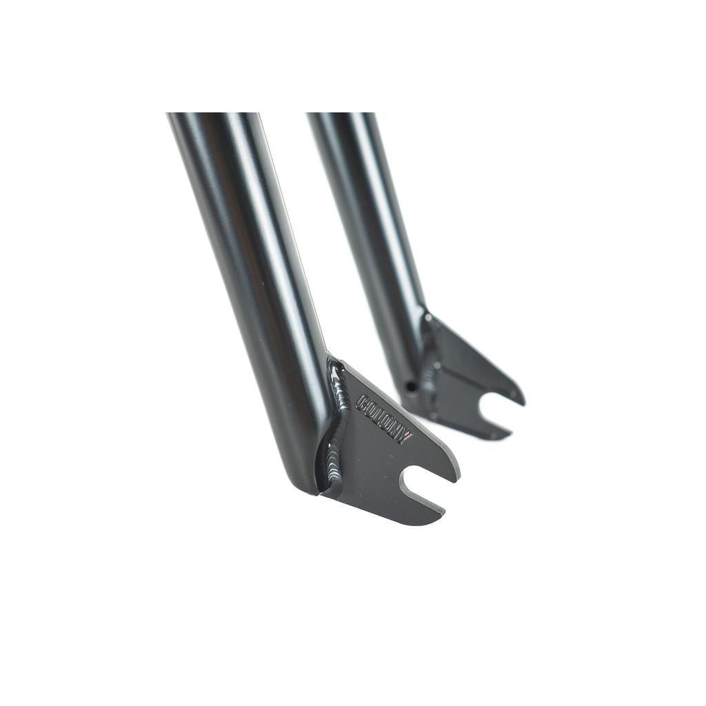 Close-up of the dropouts on a black metal bicycle fork, highlighting welding and open slots for wheel axles—engineered to match perfectly with the limited edition Colony Sect Frame Kit.