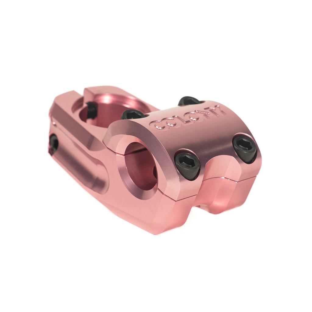 A metallic pink, low-rise Colony Variant 52mm BMX Stem with four black bolts and "SUNDAY" engraved on top, inspired by BMX style, is displayed on a white background.