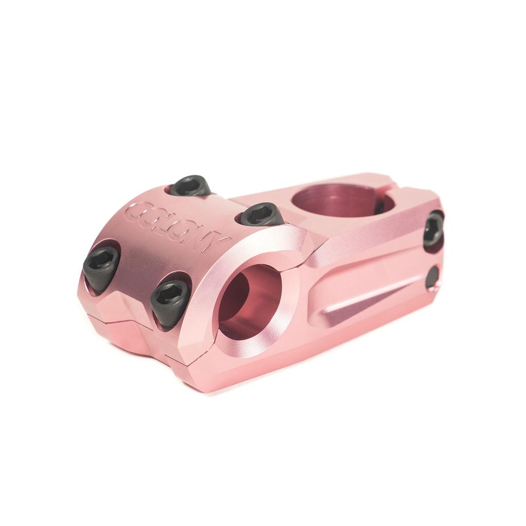 A pink anodized Colony Variant 52mm BMX Stem with black bolts, shown on a white background—a low-rise option built for enhanced performance.
