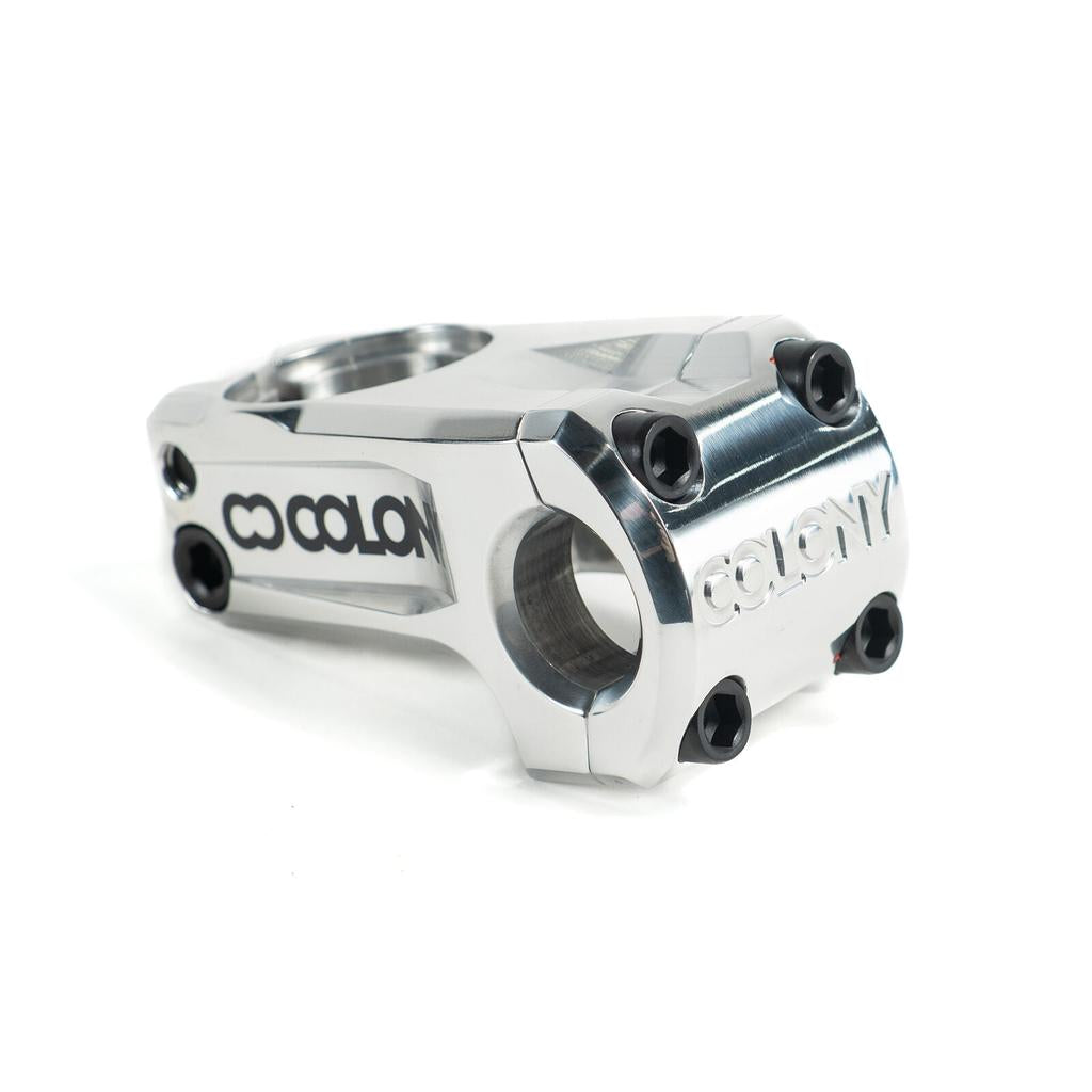 The Colony Official Front Load Stem is a lightweight silver metal BMX stem with black bolts and the Colony logo engraved on the side and front, designed for both style and performance.