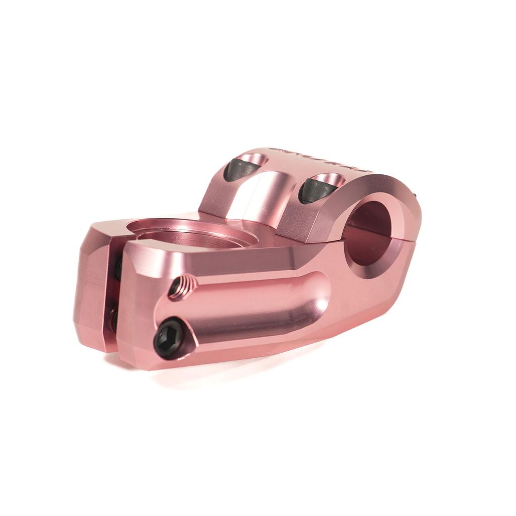 The Colony Squareback Stem is a pink anodized top load BMX stem, CNC machined from 7075T6 alloy with two clamp bolts and a hollow body, displayed on a white background.