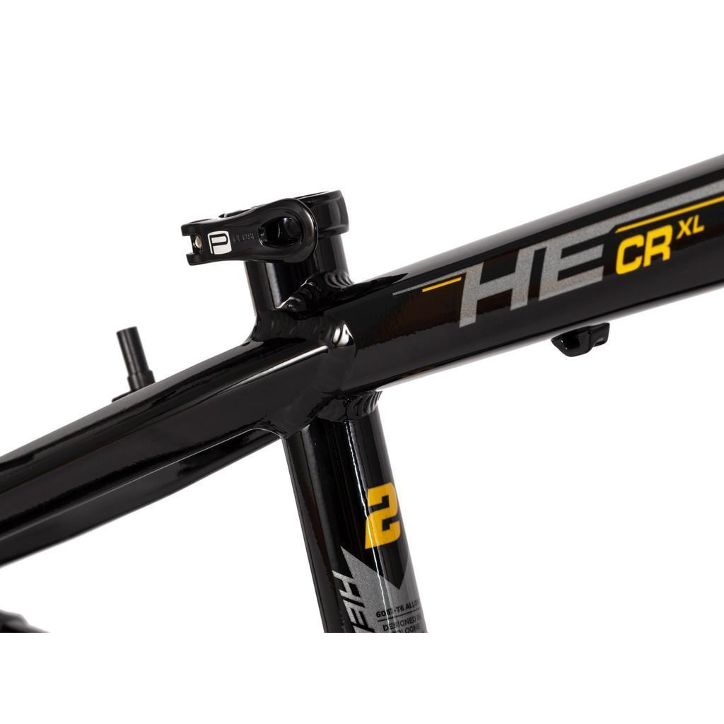 Close-up of the black Radio Raceline Helium Cruiser 24 Frame, featuring a hydroformed 6061 alloy build with "HE CR XL" and a yellow "2" on the top tube, plus part of the seat post visible.
