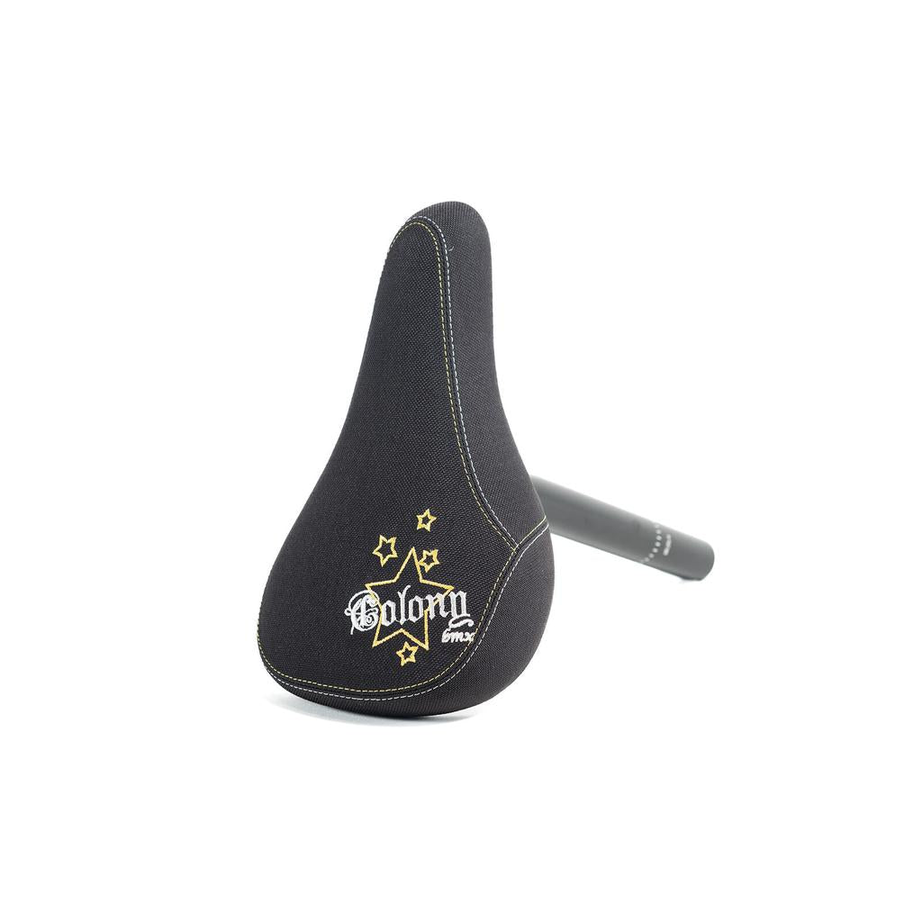 The Colony Stars 2005 Mid Combo Seat features a black BMX seat with embroidered yellow stars and "Colony 2005 Stars" on top, attached to a black combo seat post, shown against a white background.