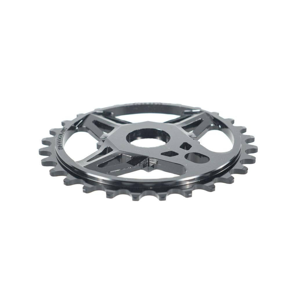A close-up of the black Colony CC Sprocket, CNC machined from 7075T6 alloy with multiple cutouts, is shown against a white background.