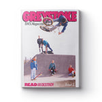 The cover of Greystoke Magazine V2 shows a BMX rider performing an aerial trick above a ramp as four skateboarders watch below, finished with bold pink and black text for a dynamic BMX magazine look.
