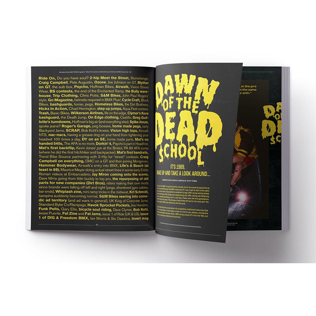 An open Grey Stoke BMX Magazine V4 shows names in yellow on black on the left page, while the right features bold yellow "Dawn of the Dead School" text over a partly hidden image—capturing BMX history in print.