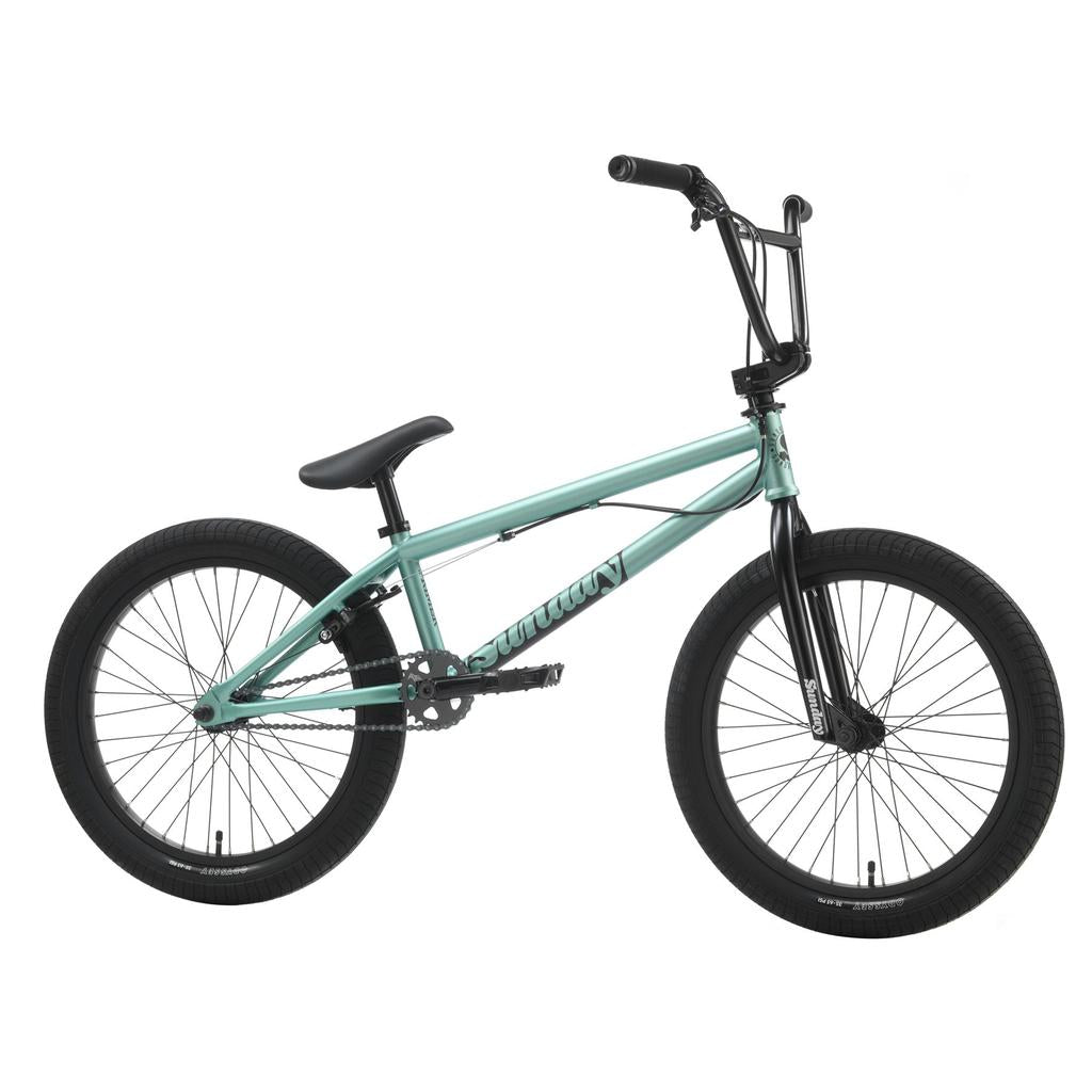The Sunday Primer Park 20 Inch Bike is shown in light blue with black handlebars, seat, pedals, and tires, displayed in a side view against a white background.