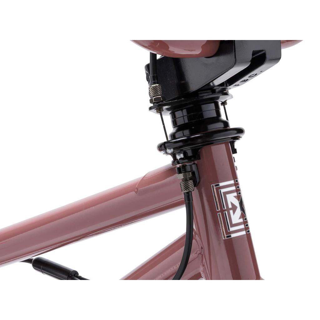 Close-up of the Fit Bike Co PRK 20 Inch Bike, highlighting its maroon frame, headset, stem, brake cables with gyro for barspins, and part of the handlebar.