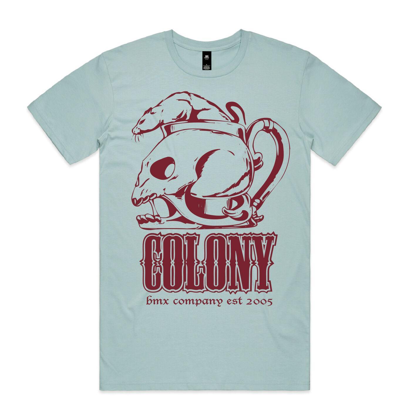 The Colony OG Rat T-Shirt features a light blue color with a maroon graphic of two rat skulls and "COLONY bmx company est 2005" printed on the front.