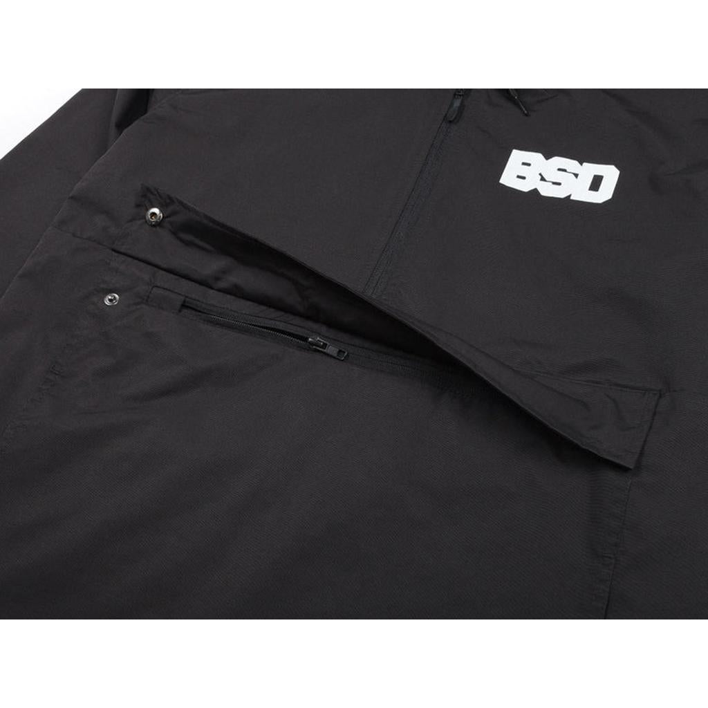 Close-up of the BSD Athletic 91 Windbreaker Jacket, showcasing a snapped flap and a zippered pocket below on this stylish, water-resistant nylon jacket.