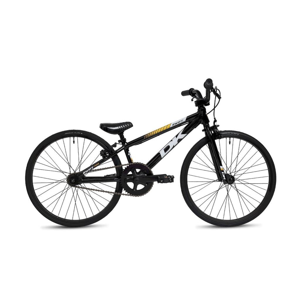 The DK Swift Micro 18 Inch Bike 2025 is a black BMX-style bicycle with a lightweight aluminum frame, horizontal top tube, slim tires, straight handlebars, and yellow and white accents, shown in profile view.
