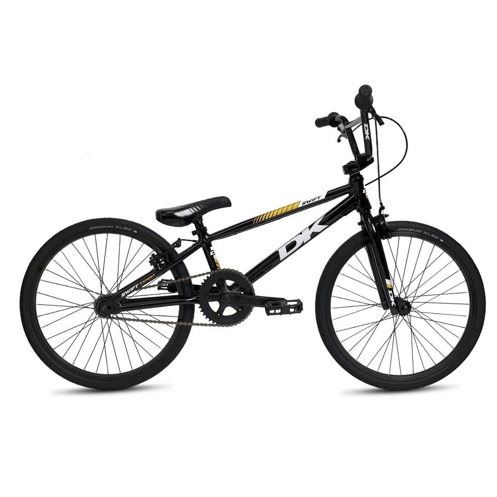 The DK Swift Expert 20 Inch Bike 2025 is a black BMX with straight handlebars, padded seat, and all-terrain tires, displayed in profile against a white background.