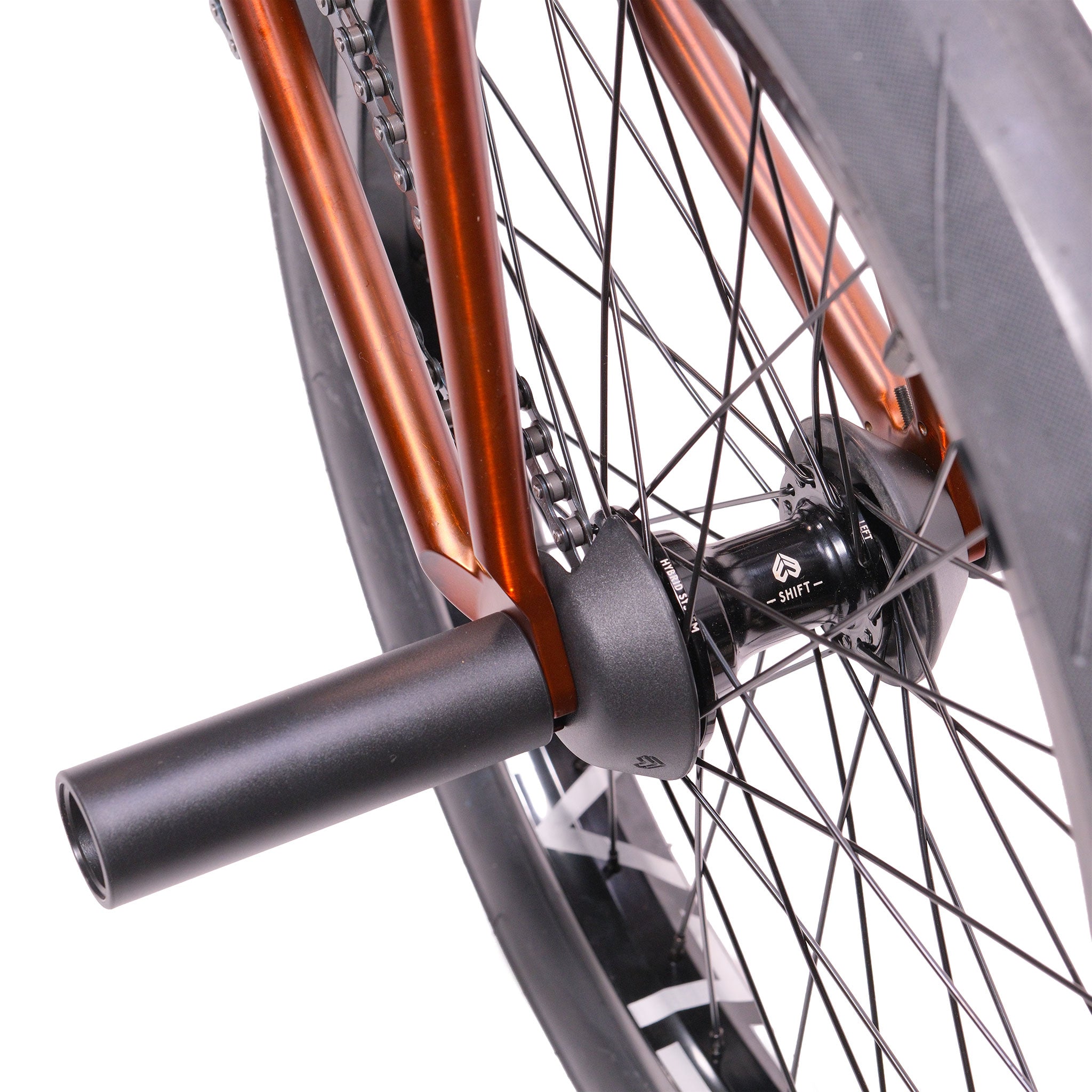 Close-up of the Cult Dak X Eclat Custom 'Pat Freyne Signature' BMX's rear wheel, highlighting the spokes, stunt axle peg, and metallic frame details.