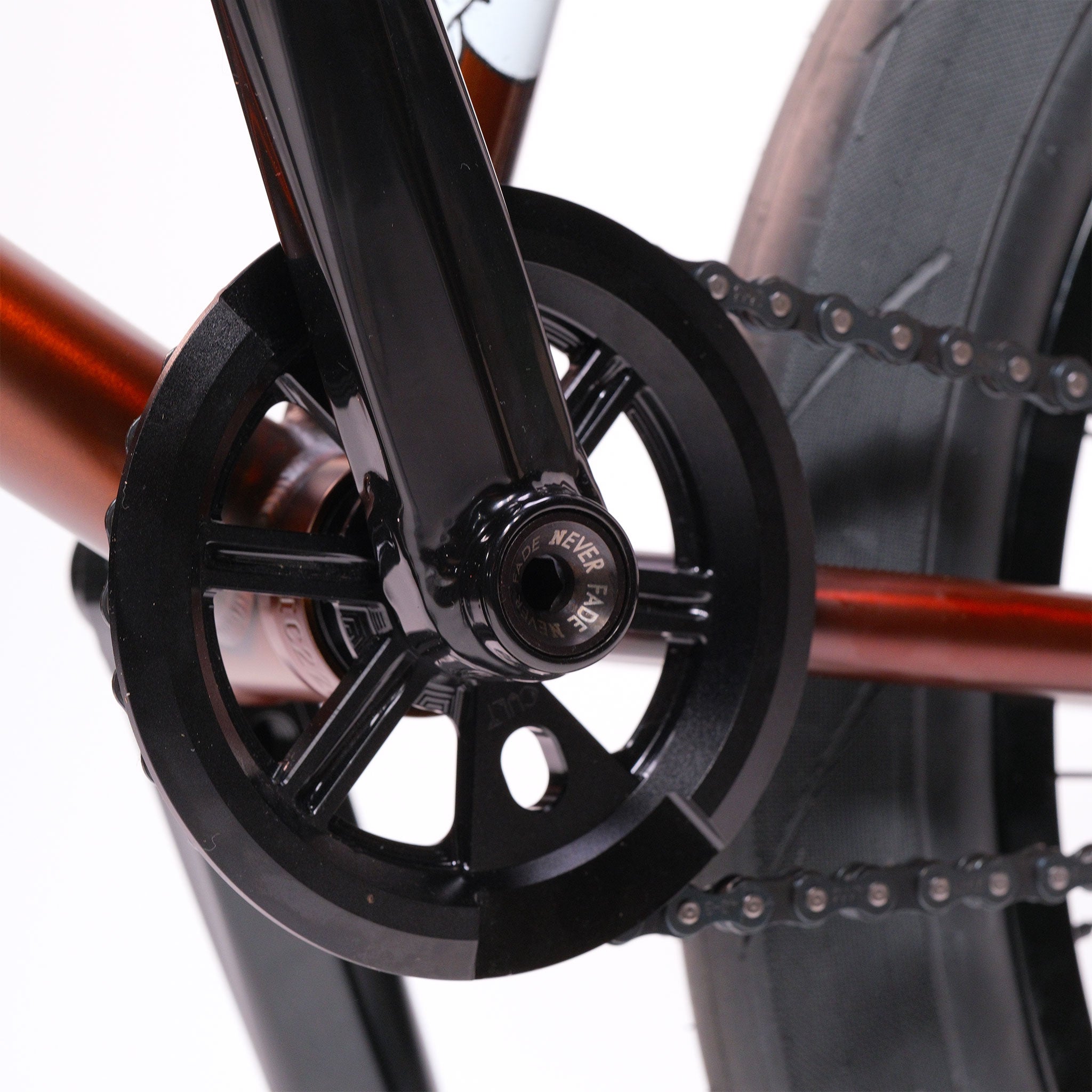 Close-up of a BMX bike crankset and chainring with black crank arm, black chainring, and rear tire—featured on the Cult Dak X Eclat Custom 'Pat Freyne Signature'.