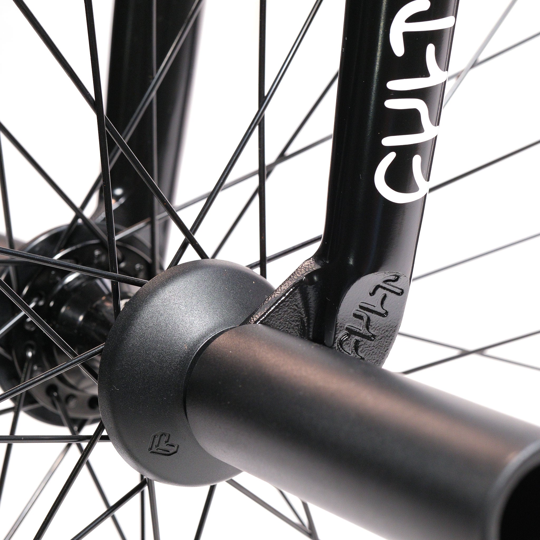 Close-up of a black BMX fork with white lettering, black spokes, hub, and axle peg—ideal for the Cult Dak X Eclat Custom 'Pat Freyne Signature' build.