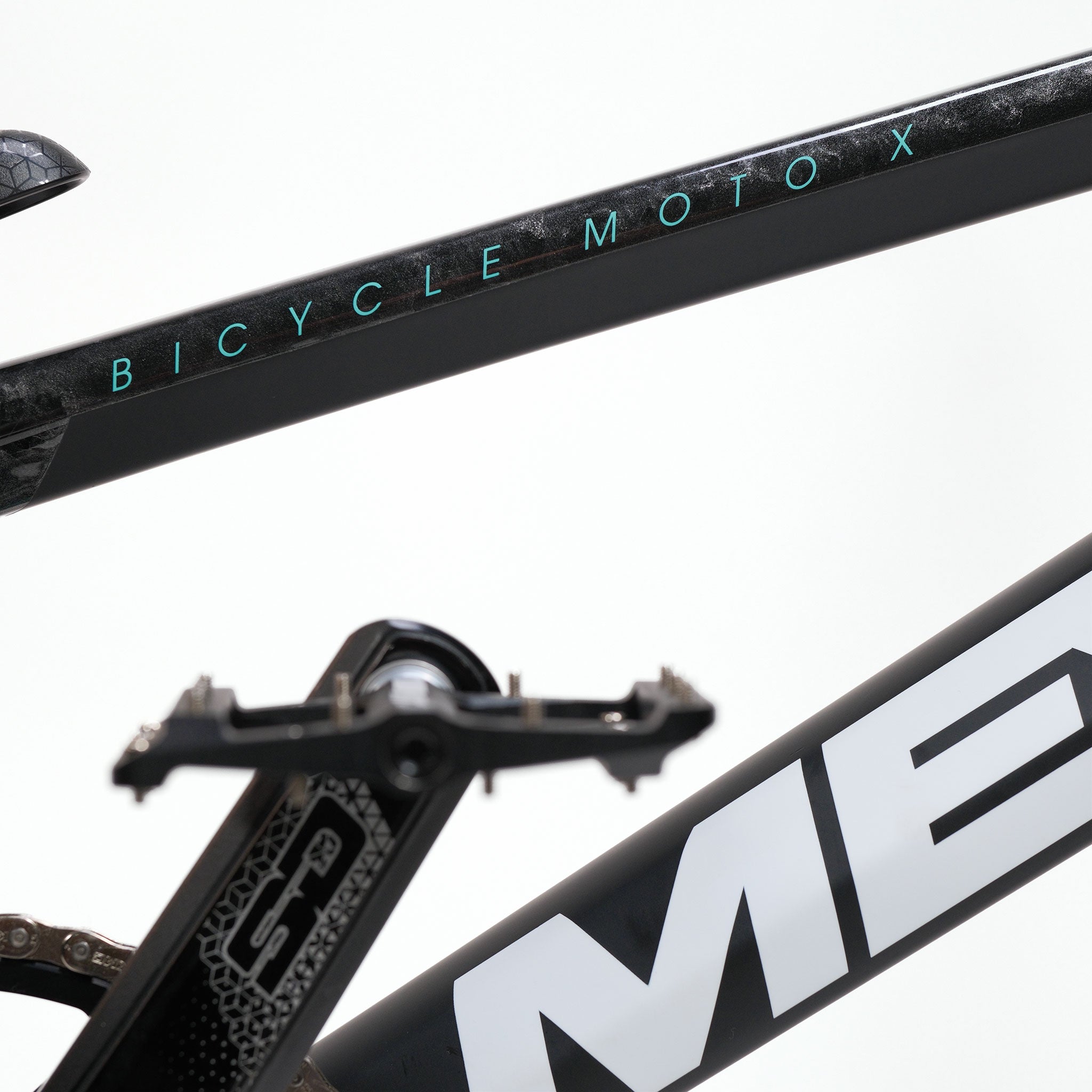 Close-up of a black carbon BMX race frame labeled "BICYCLE MOTO X," with a visible pedal and part of a white logo on a neutral background, reminiscent of the sleek design found in models like the Meybo HSX Carbon Pro XXL Race Bike.