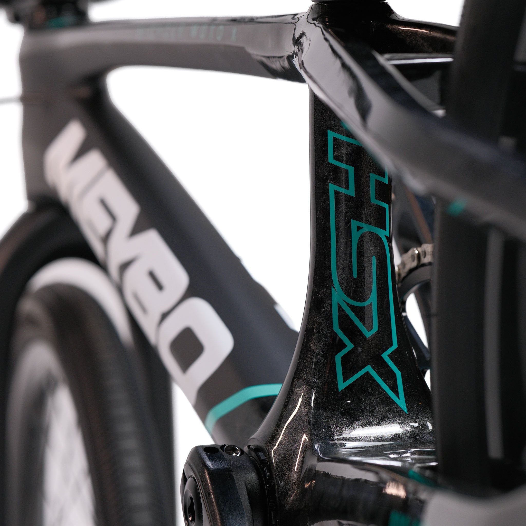 Close-up of the Meybo HSX Carbon Pro XXL Race Bike, featuring a black carbon BMX race frame with turquoise accents and "HSX" lettering visible, part of the tire, and the Meybo brand on the frame.