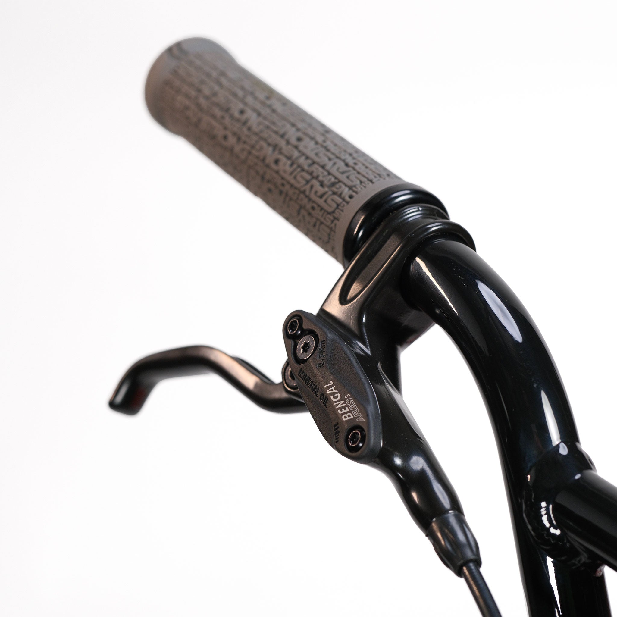 Close-up of the Stay Strong V5.1 Junior Race Bike's black BMX handlebar featuring a textured grip and Tektro brake lever, set against a white background to highlight its lightweight aluminium construction, ideal for junior disc frame setups.