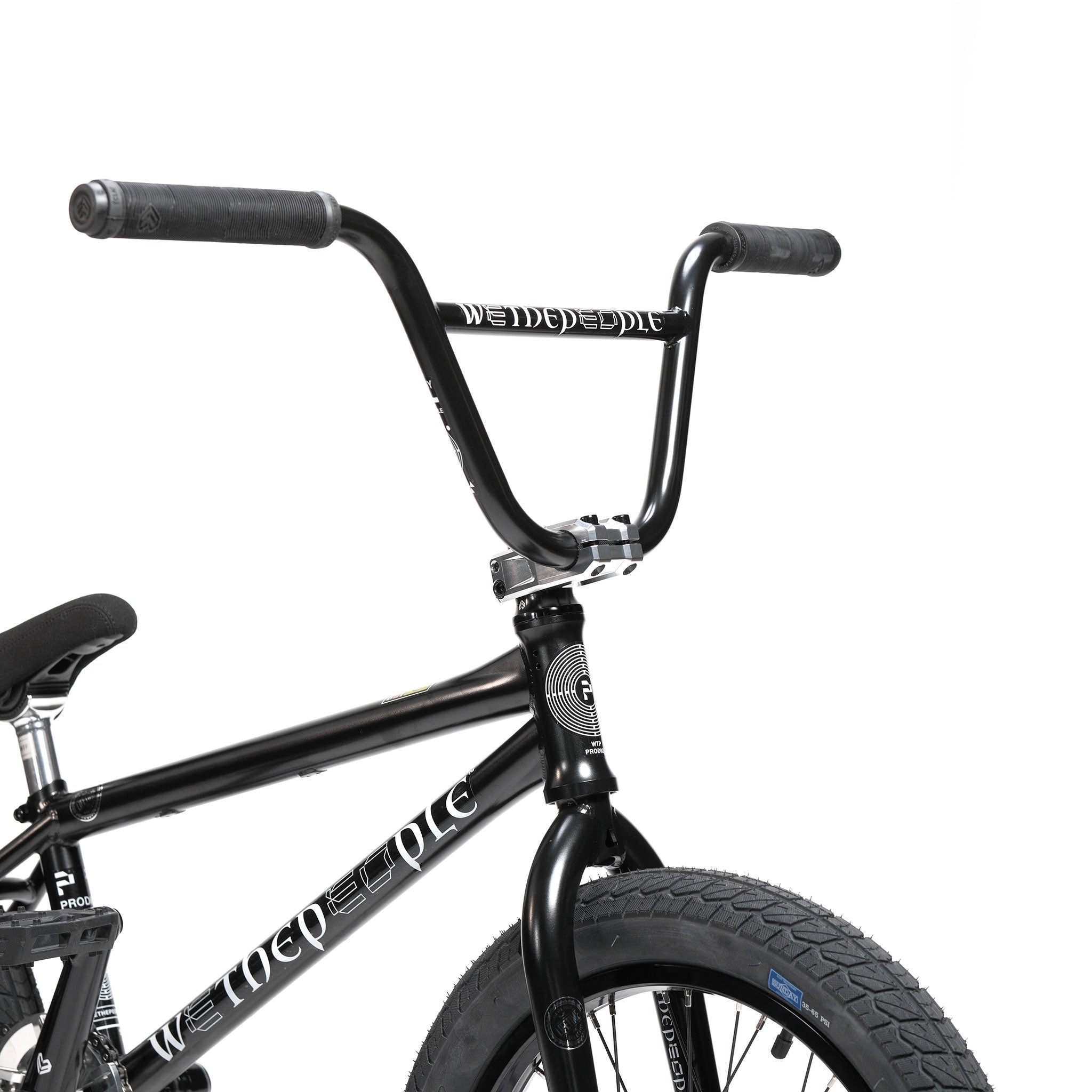 Close-up of a black BMX bike’s handlebars, front tire, and part of the frame featuring the “WeThePeople” brand logo on a white background—this model highlights the precision engineering of the Wethepeople Prodi-G-Unit 18 Inch Custom Bike and is fitted with high-quality Eclat parts.