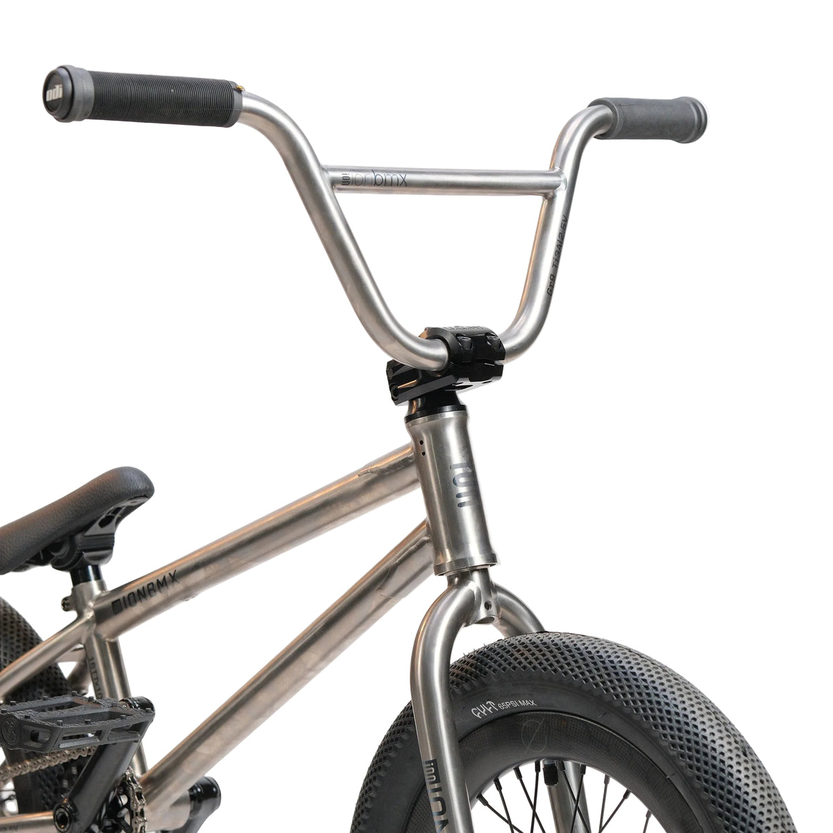 Close-up of the ION BMX Ti16 Custom Titanium 16 Inch Bike in silver, highlighting the handlebars, front wheel, headset, and part of its lightweight titanium frame.