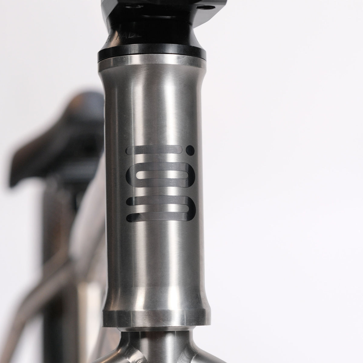 Close-up of the brushed metal head tube on the ION BMX Ti16 Custom Titanium 16 Inch Bike, featuring the brand’s black “ION” logo against a plain white background—perfectly showcasing the premium craftsmanship of this lightweight BMX.
