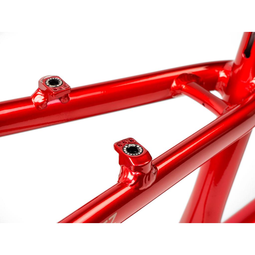 Close-up of the Radio Raceline Quartz 2025 Pro XL Cruiser Frame, a shiny red aluminium race frame with two seat stay mounts featuring integrated bolt holes, set against a white background.