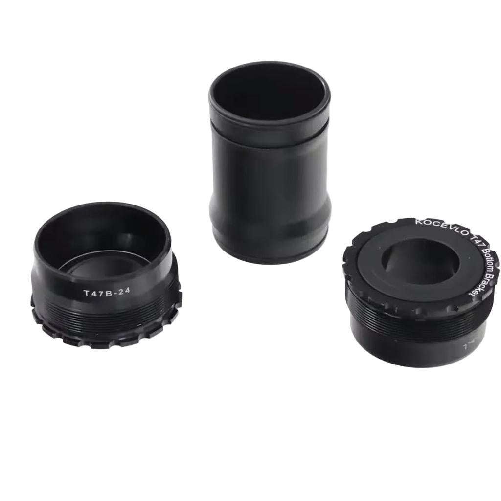 Four T47 Internal 24mm 85.5mm Bottom Bracket parts in black metal and one clear plastic ring are arranged on a white background.