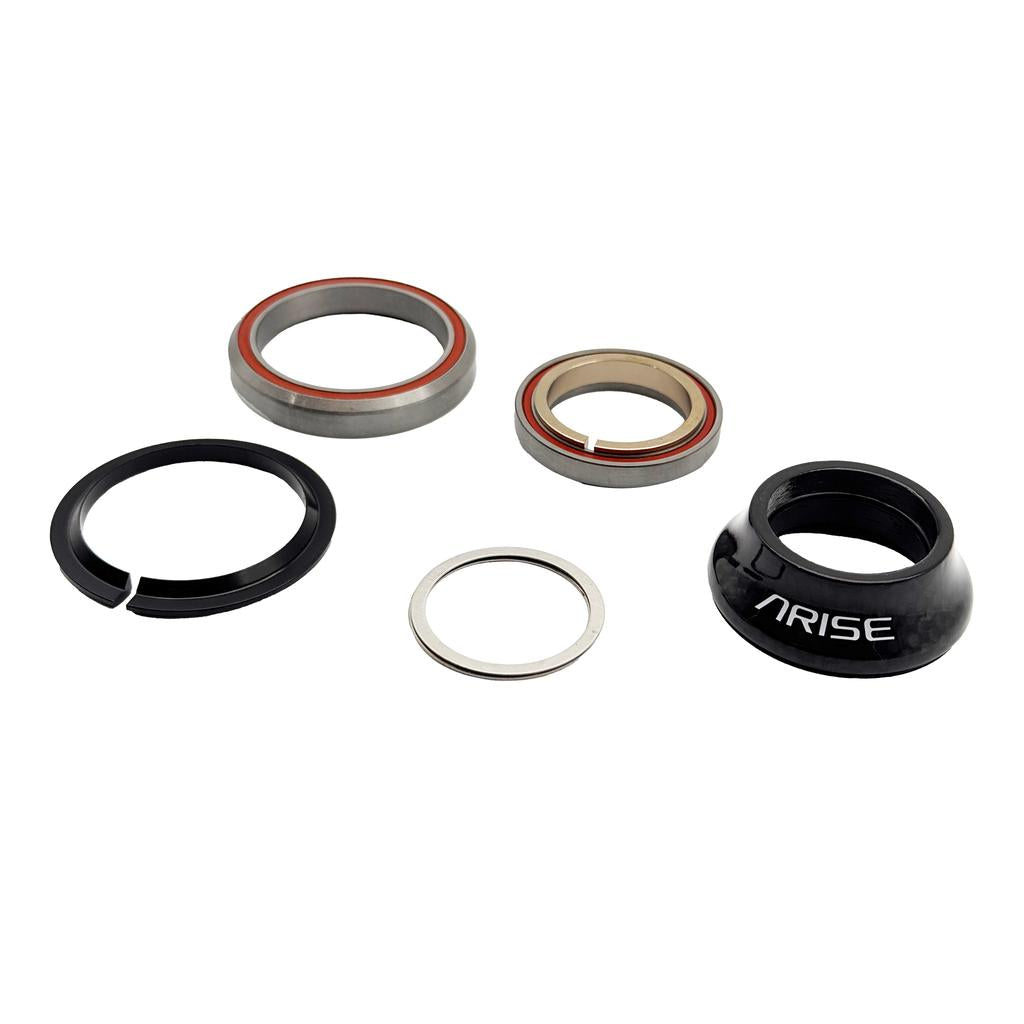 Five Arise Crystal 15 Tapered Headset components—including stainless steel sealed bearings, a split ring, a spacer, and a carbon fibre top cap labeled "ARISE"—are arranged on a white background.