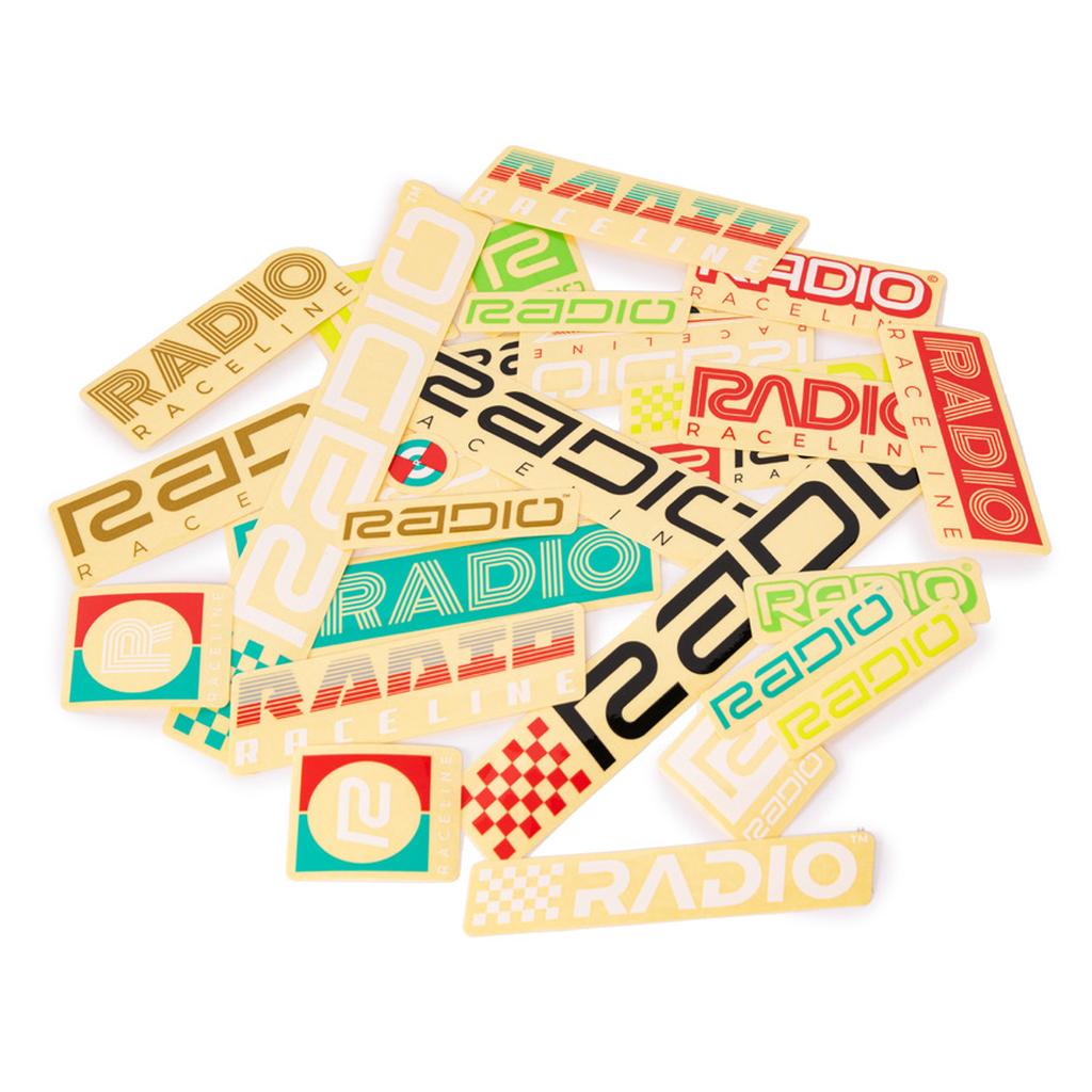 The Radio Raceline Assorted Sticker Pack features a variety of high-quality rectangular stickers showcasing different “RADIO RACELINE” logos and designs in vibrant colors such as red, green, black, and yellow on a white background—ideal for anyone eager to display their passion for RADIO RACELINE.