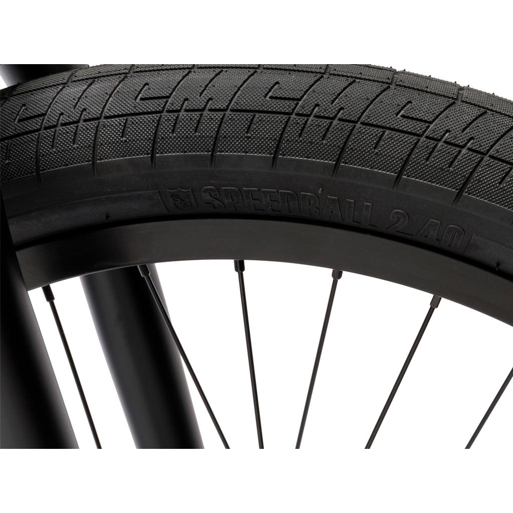 Close-up of a black BMX wheel with spokes, featuring the "Speedball 2.40" tire—ideal for a 22-inch BMX bike like the Fit Bike Co Series 22 Inch Bike.
