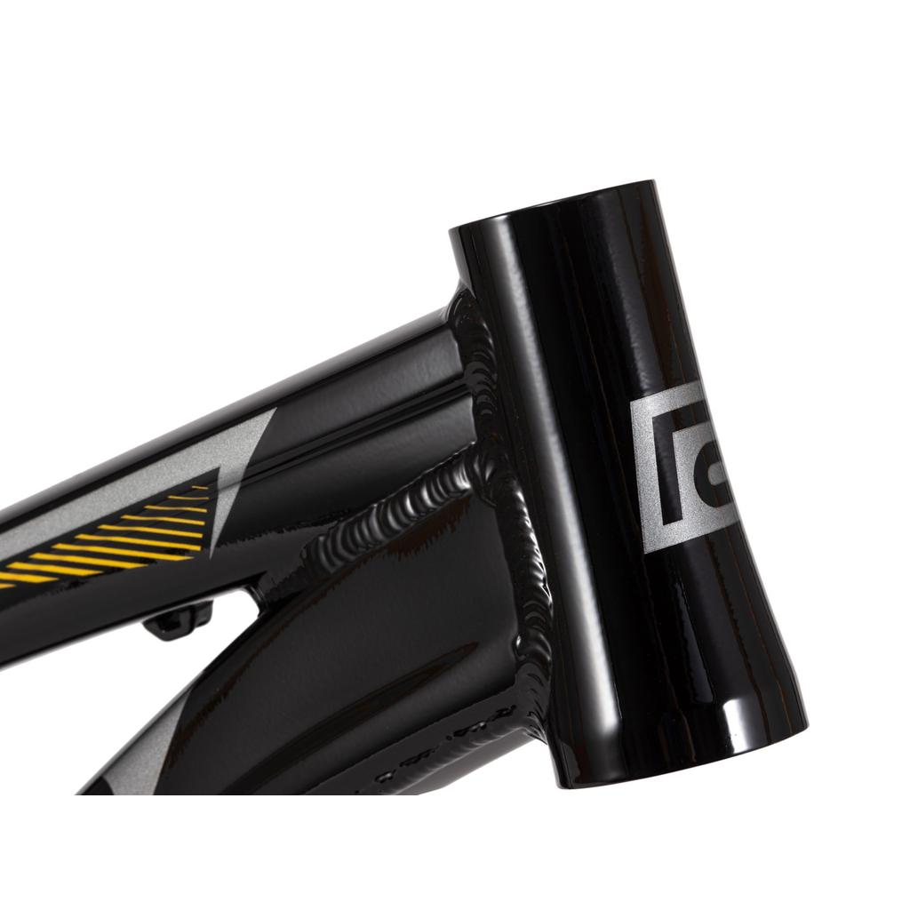 Close-up of the Radio Raceline Helium Cruiser 24 Frame, a black hydroformed 6061 alloy bike frame showing the head tube with a silver logo, visible welds, and yellow-gray accent details.