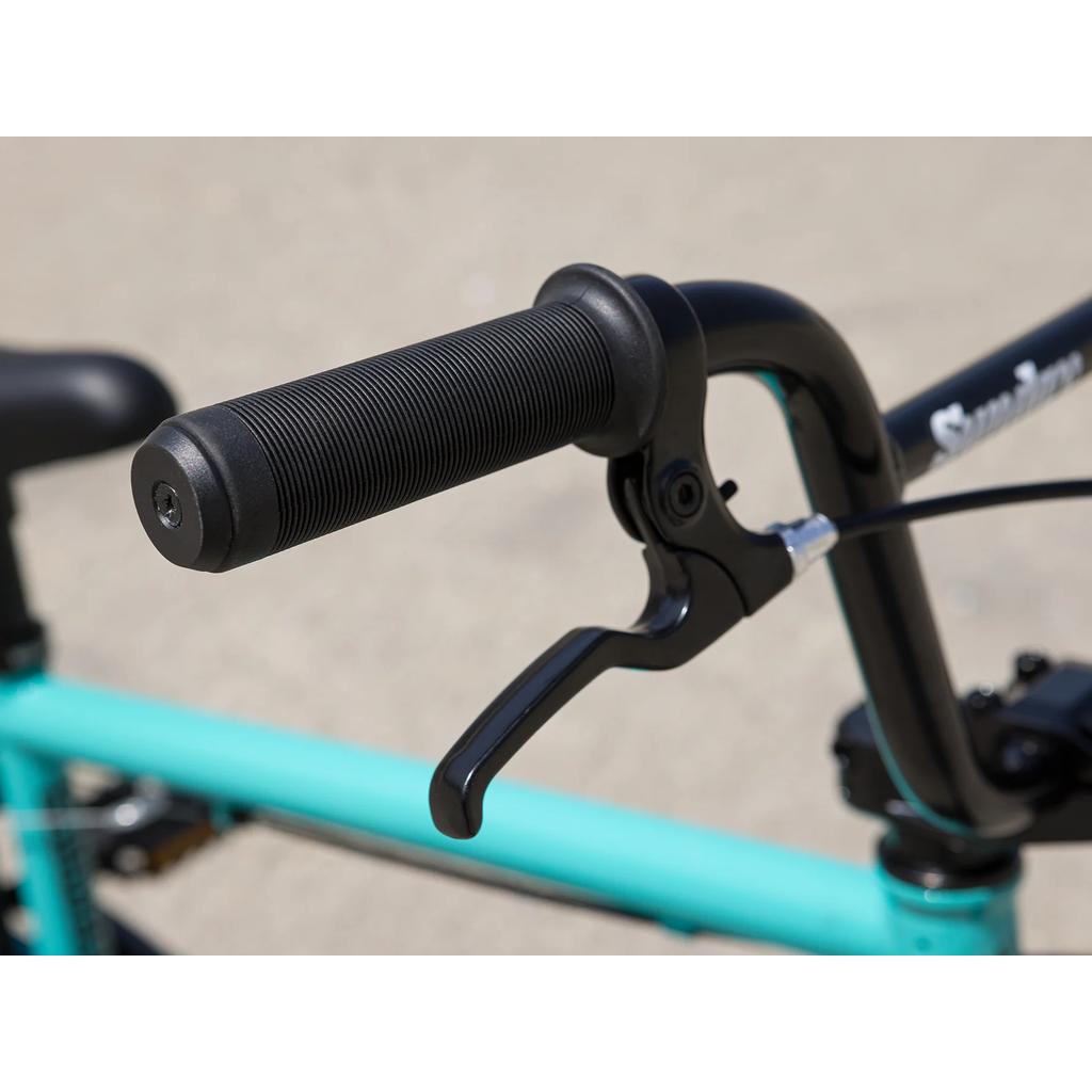 Close-up of a bicycle handlebar with a black grip and brake lever, showing part of the turquoise Sunday Primer 16 Inch Bike (2025) frame—perfect for upgrading your 16” BMX with Odyssey Springfield Brakes.