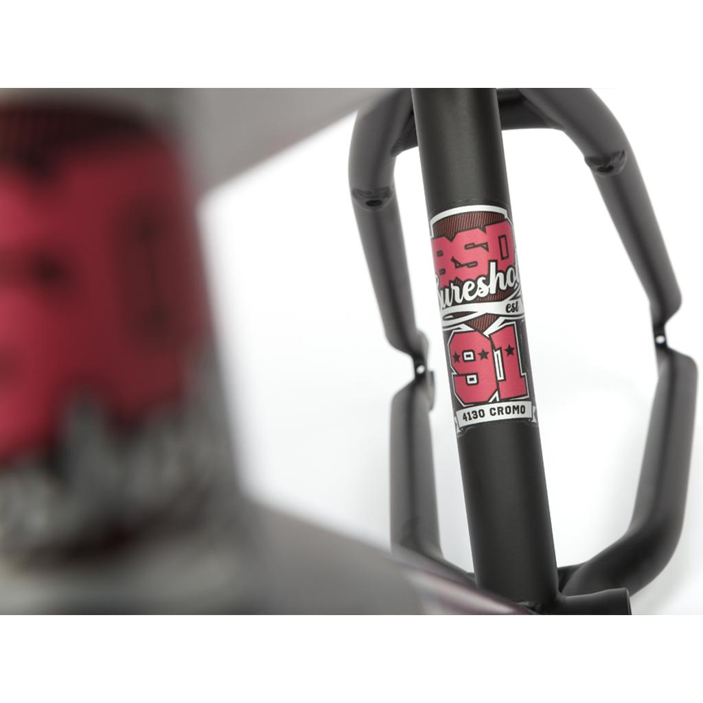 Close-up of the BSD Sureshot Frame with a “BSD Sureshot 991 4130 Cromo” decal, showing another blurred frame section in front. This all-round BMX frame offers versatility and has removable brake mounts.