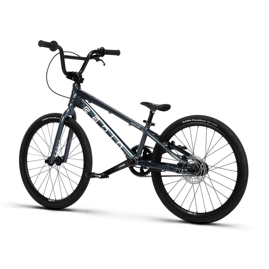 The Radio Xenon Expert Disc 20 Inch Bike, featuring a blue lightweight alloy frame, wide handlebars, black saddle, and thick tires, is displayed against a white background.