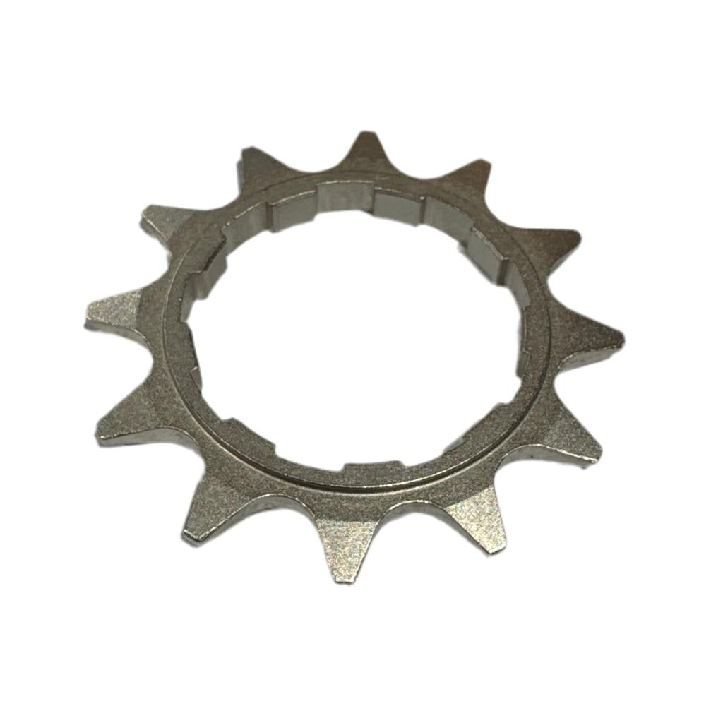 The CNC 1/2x1/8 HG Cassette Cog is a heat-treated chromoly cog with 11 teeth and a notched inner ring, compatible with 1/2x1/8 chains, shown on a white background.