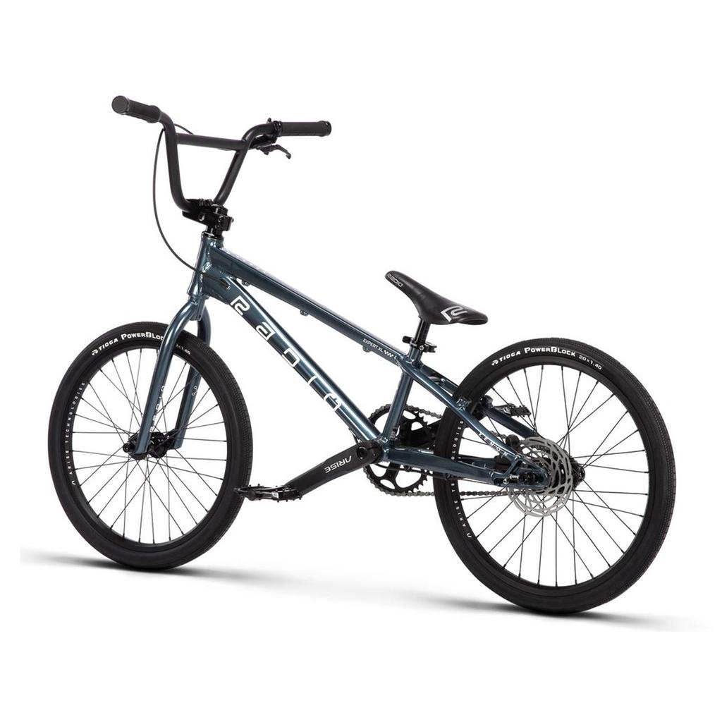 The Radio Xenon Expert XL Disc 20 Inch Bike is shown on a white background, featuring a blue lightweight alloy frame, black tires, upright handlebars, a padded seat, and chain drive.