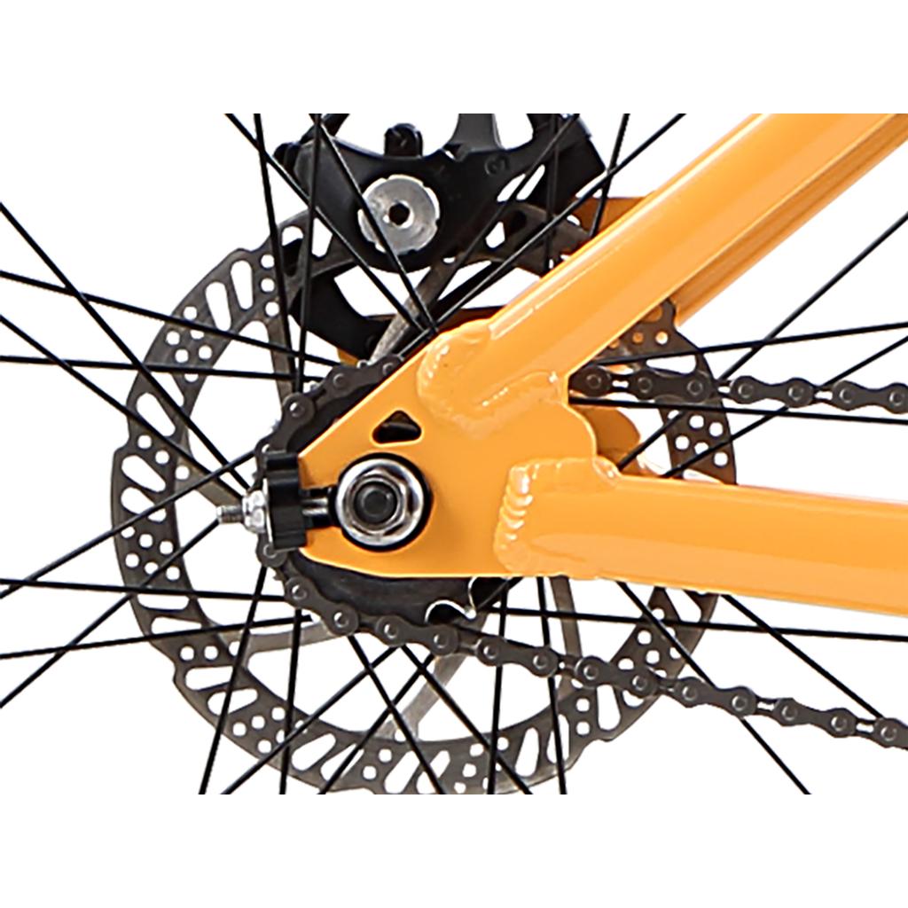 Close-up of the Redline RL 275 27.5 Inch Bike’s rear wheel, showcasing the chain, disc brake rotor, black spokes, and a section of its bold orange frame.