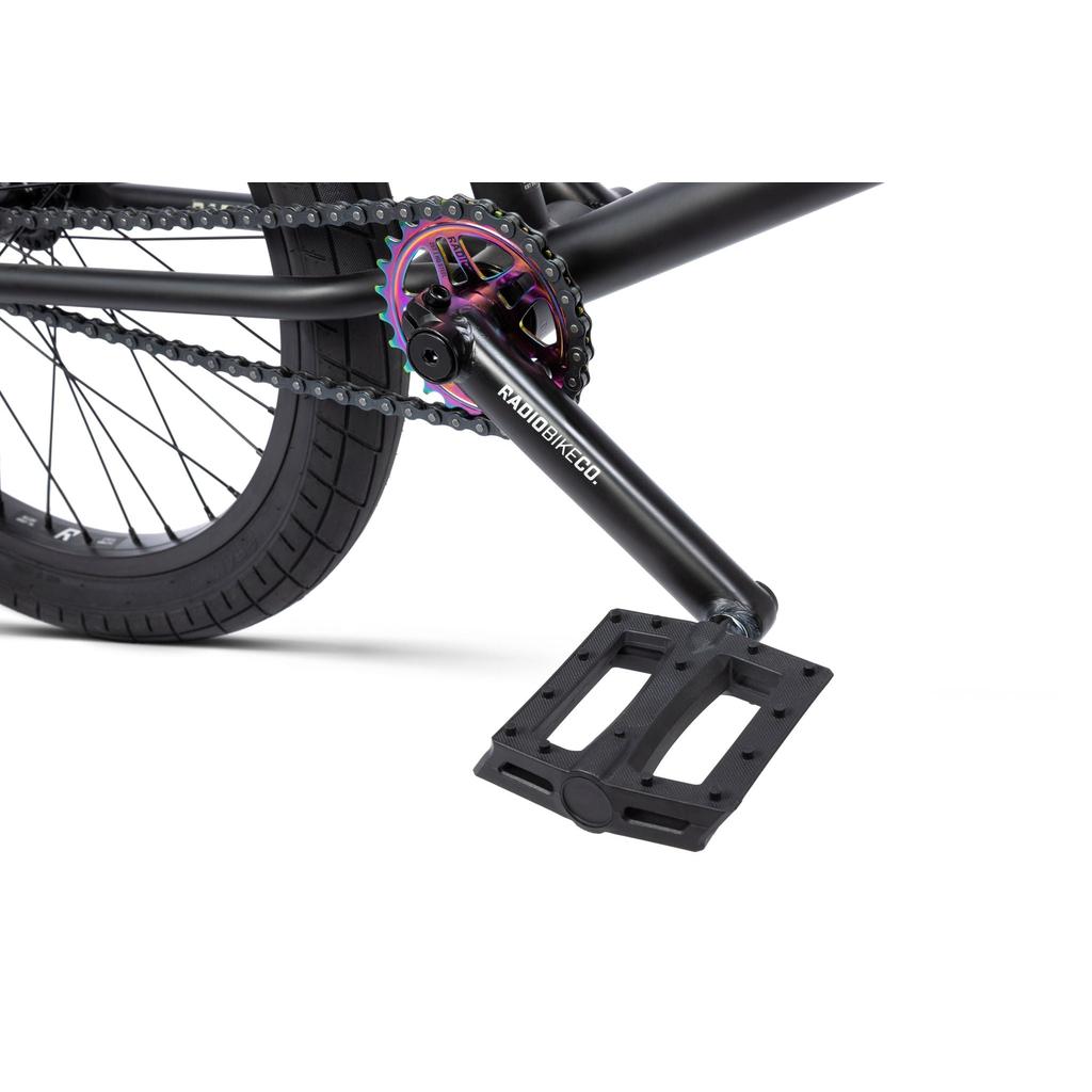 Close-up of the Radio Evol XL 20 Inch Bike crankset with a black pedal, iridescent chainring, and "Radiobikeco" branding on the crank arm.