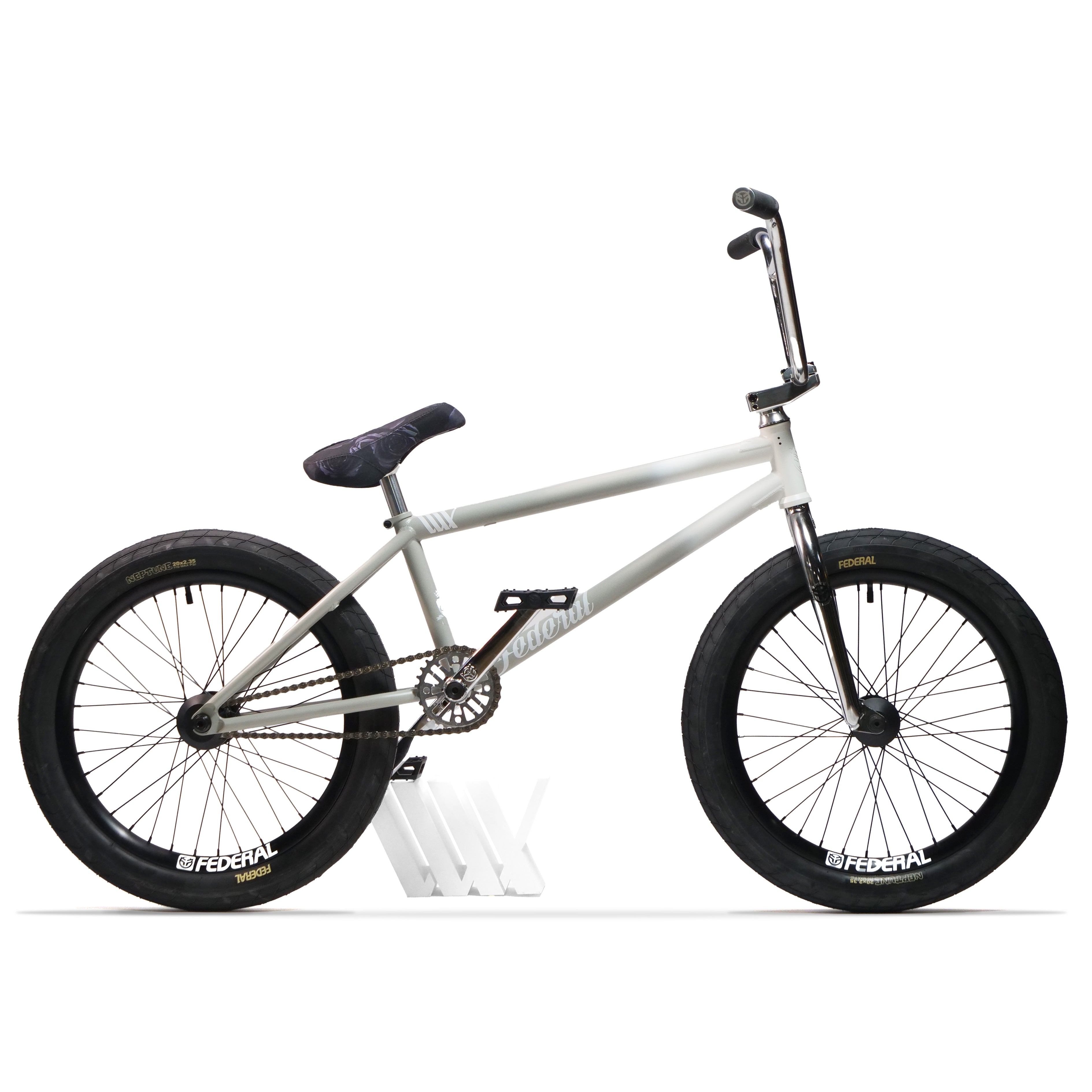 Federal Lacey x Chrome Custom 20 Inch Bike: a silver BMX with Federal Lacey 3 Frame, Federal Assault 22 Forks, black wheels, tires, seat, and handlebars. Shown on a white stand against a plain white background.