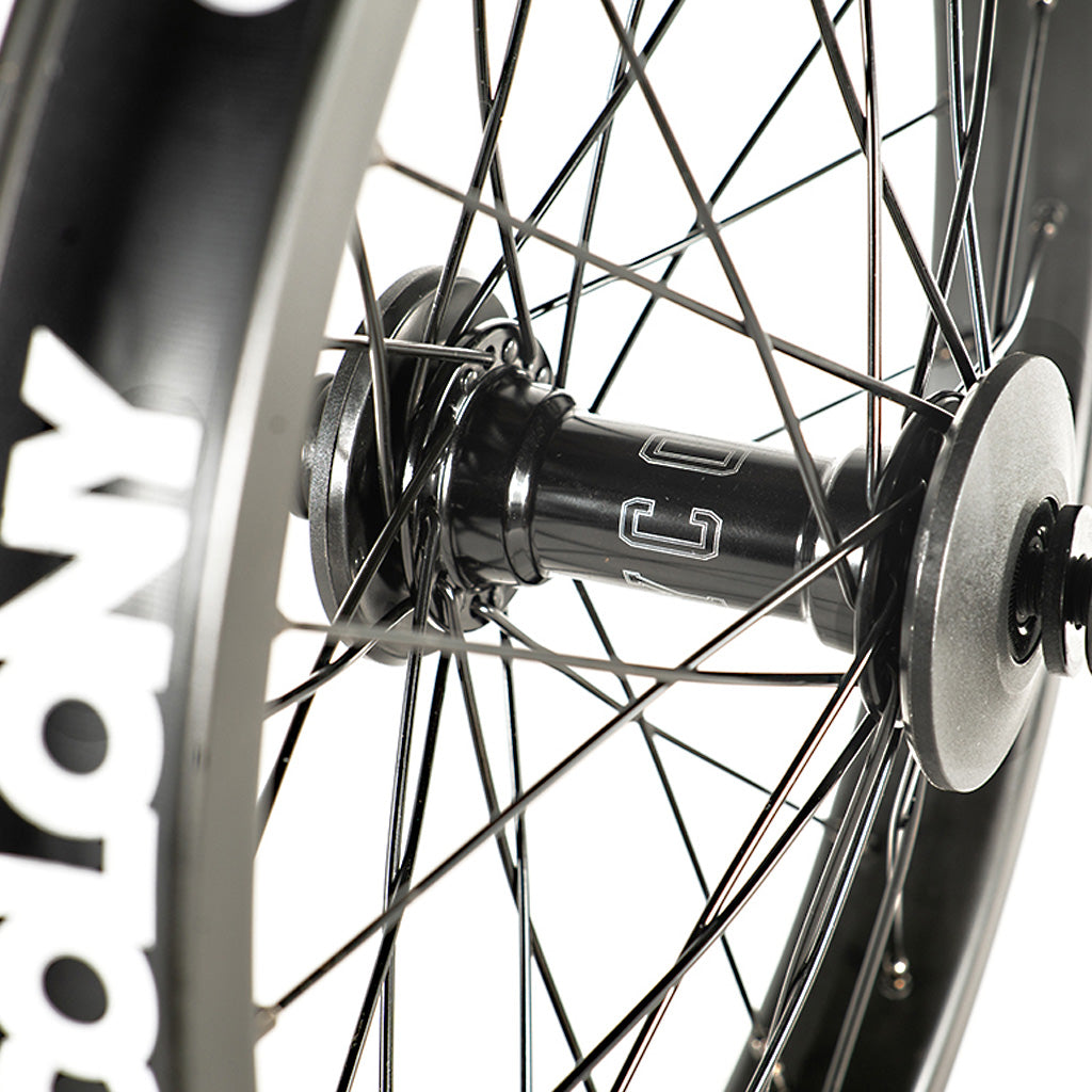 A close up of a Colony Pintour 18 Inch Front Wheel set with a logo on the black wheel.